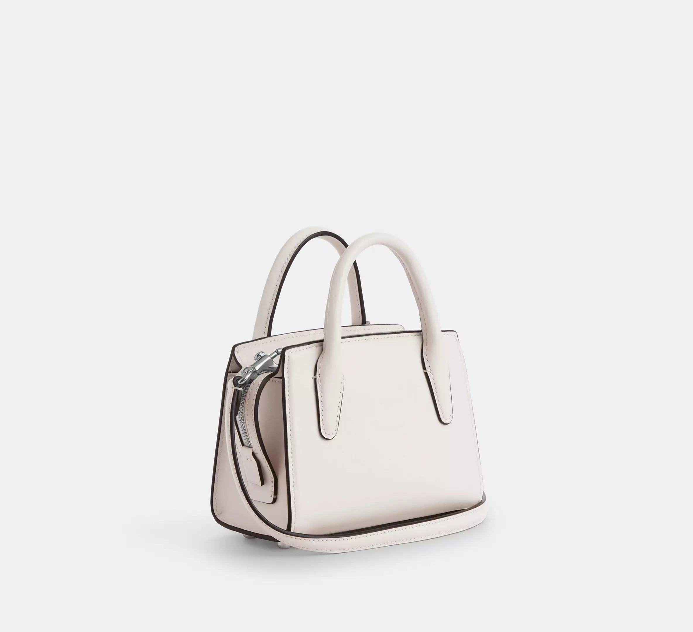 Top handle detail of Coach Andrea Carryall in crisp white finish