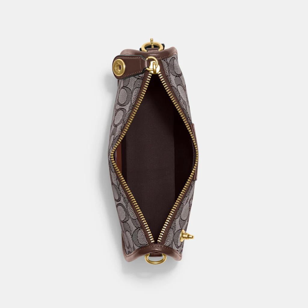 Top view of Coach Swinger Bag – featuring secure zipper closure and stylish jacquard fabric with iconic Coach branding.