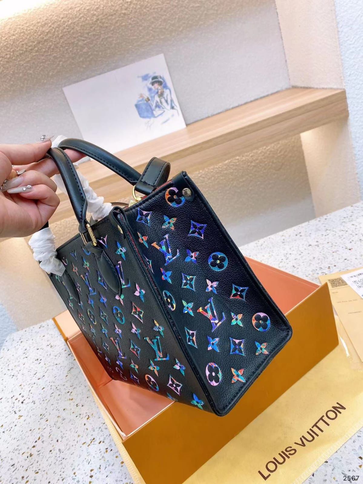Side angle of LV OnTheGo Rainbow Tote Bag showing multicolor gradient design