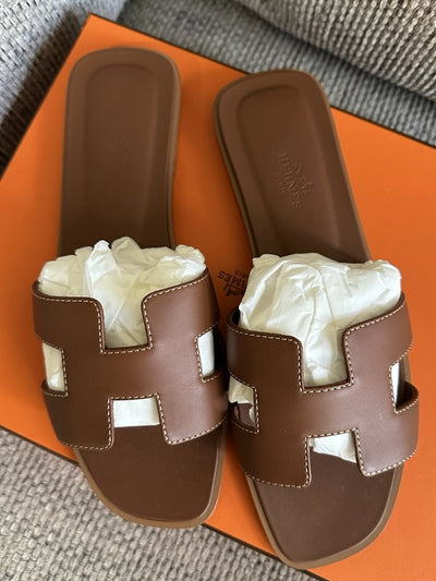 HERMÈS Brown Gold Calfskin Oran Sandals hover