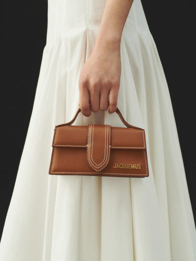 The Bambino Small handbag with adjustable crossbody strap. hover