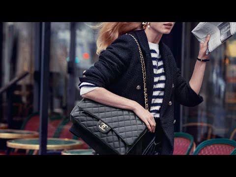 Side view of CHANEL Classic Double Flap Bag in black leather, a must-have luxury accessory for fashion lovers.