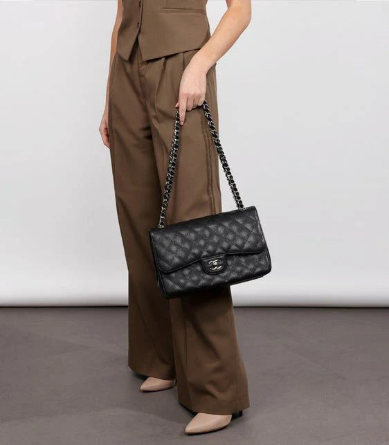 CHANEL Classic Double Flap Bag, black quilted leather handbag with gold hardware, a sophisticated luxury piece.
