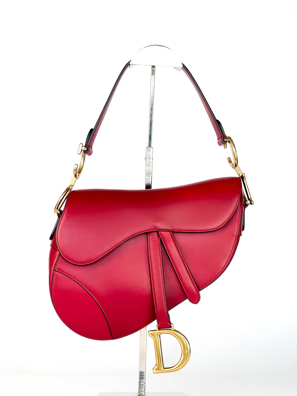 Red Christian Dior Saddle Bag crafted in smooth leather with iconic saddle silhouette and gold-tone details