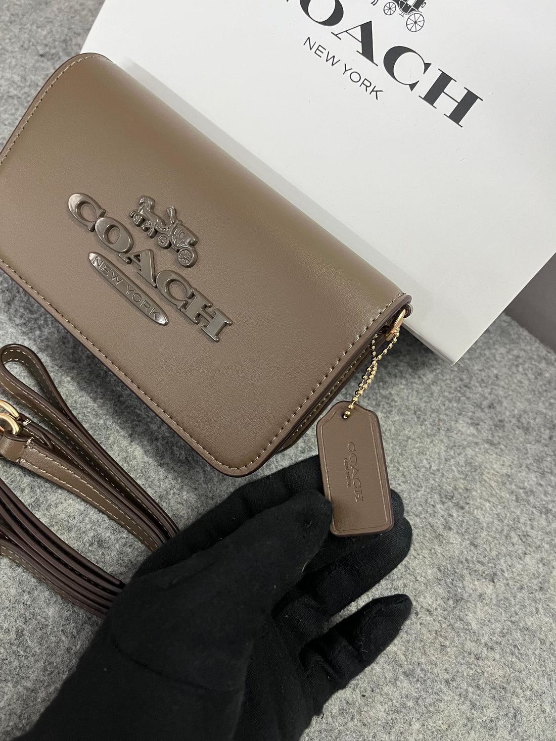 Front view of Coach Tony Mini Crossbody Leather Bag in brown with gold-tone accents