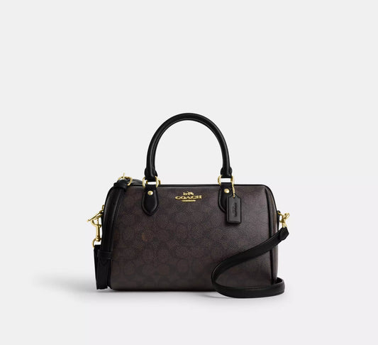 Coach Rowan Satchel Bag in brown and black signature canvas, stylish front view showcasing the iconic design.