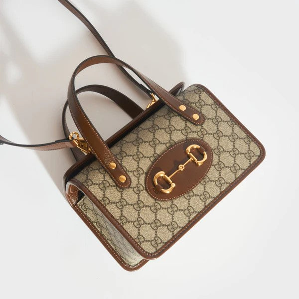 Side angle of Gucci Horsebit bag – elegant silhouette with smooth leather and antique gold-tone hardware.