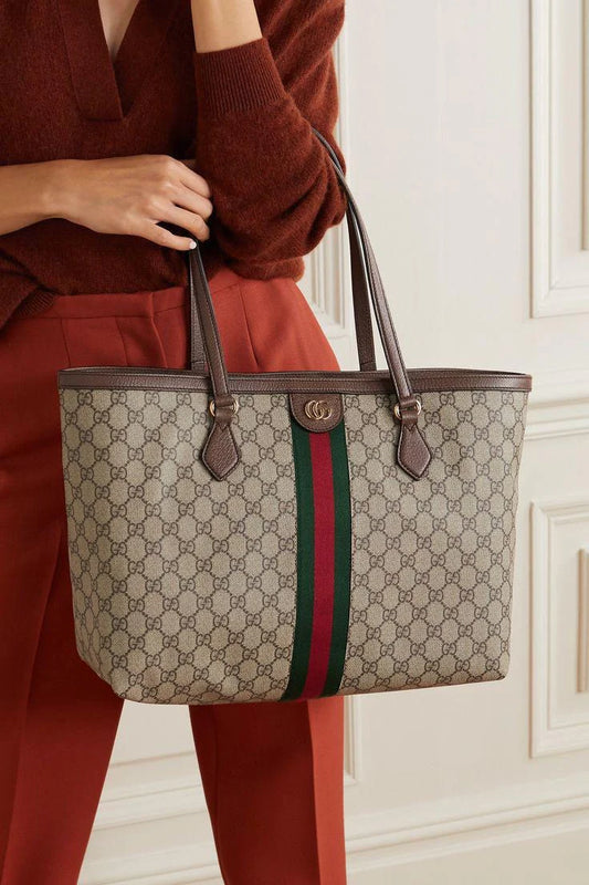 Close-up of GUCCI leather tote bag, highlighting the signature GG pattern and luxurious craftsmanship.