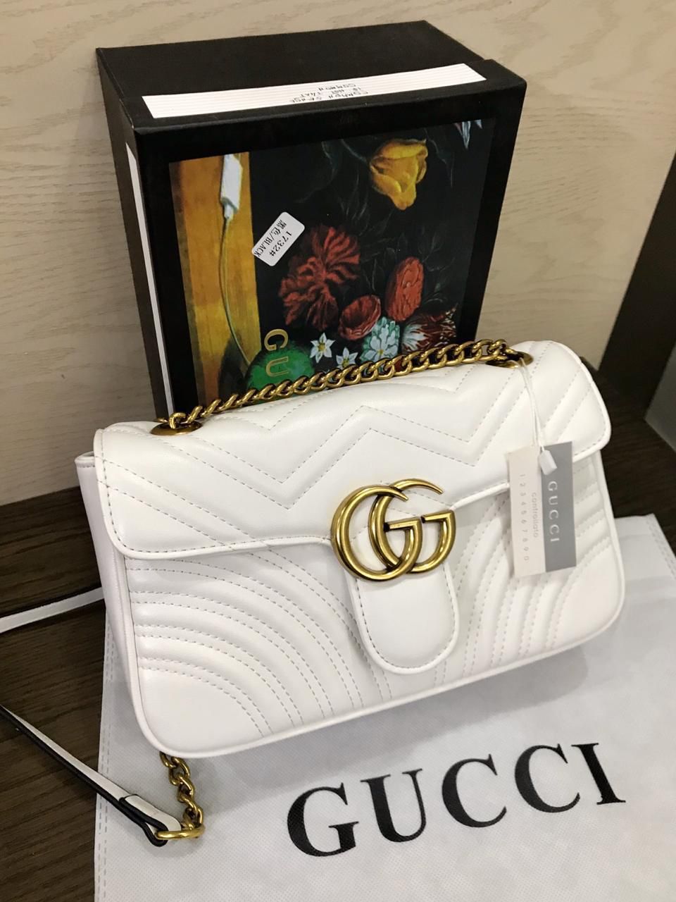 Black Gucci Marmont Shoulder Bag with soft matelassé leather and adjustable chain shoulder strap.

