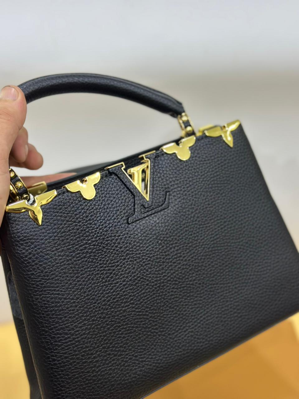 Front view of Louis Vuitton women’s handbag – luxury designer bag with monogram canvas and elegant silhouette.