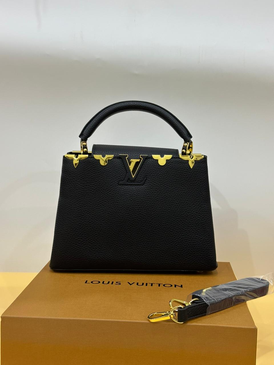 Model carrying Louis Vuitton designer bag – statement women’s fashion accessory perfect for upscale everyday style.