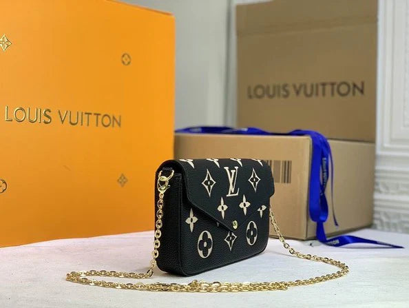 Side view of black Louis Vuitton Félicie Pochette – compact luxury leather bag featuring gold-tone chain and smooth finish.