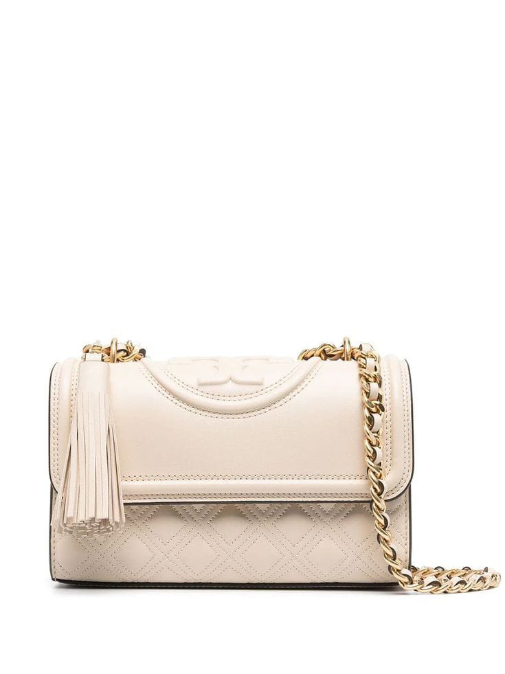 Side angle of Tory Burch Britten leather shoulder bag – elegant and adjustable handbag for women with gold hardware and structured shape.