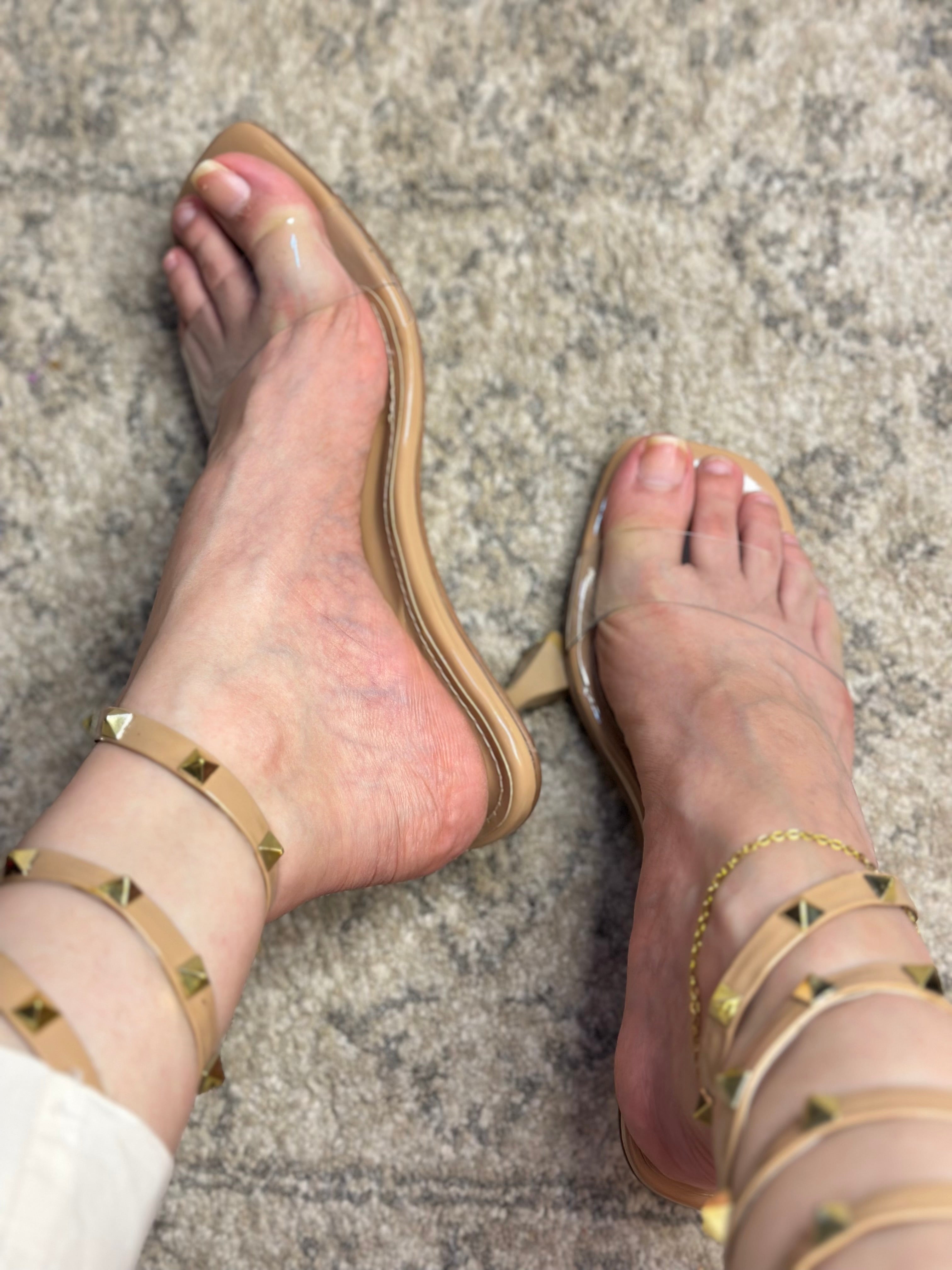 Model wearing Valentino Rockstud lace-up heels – fashionable women’s sandals styled for chic evening or occasion wear.