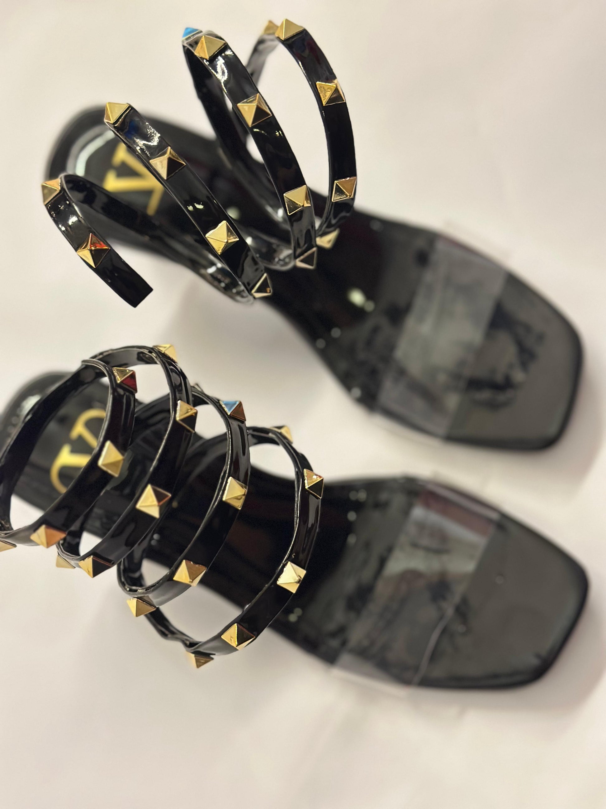 Close-up of Valentino Rockstud lace-up straps – high-quality leather with metallic stud detailing on women’s sandals.