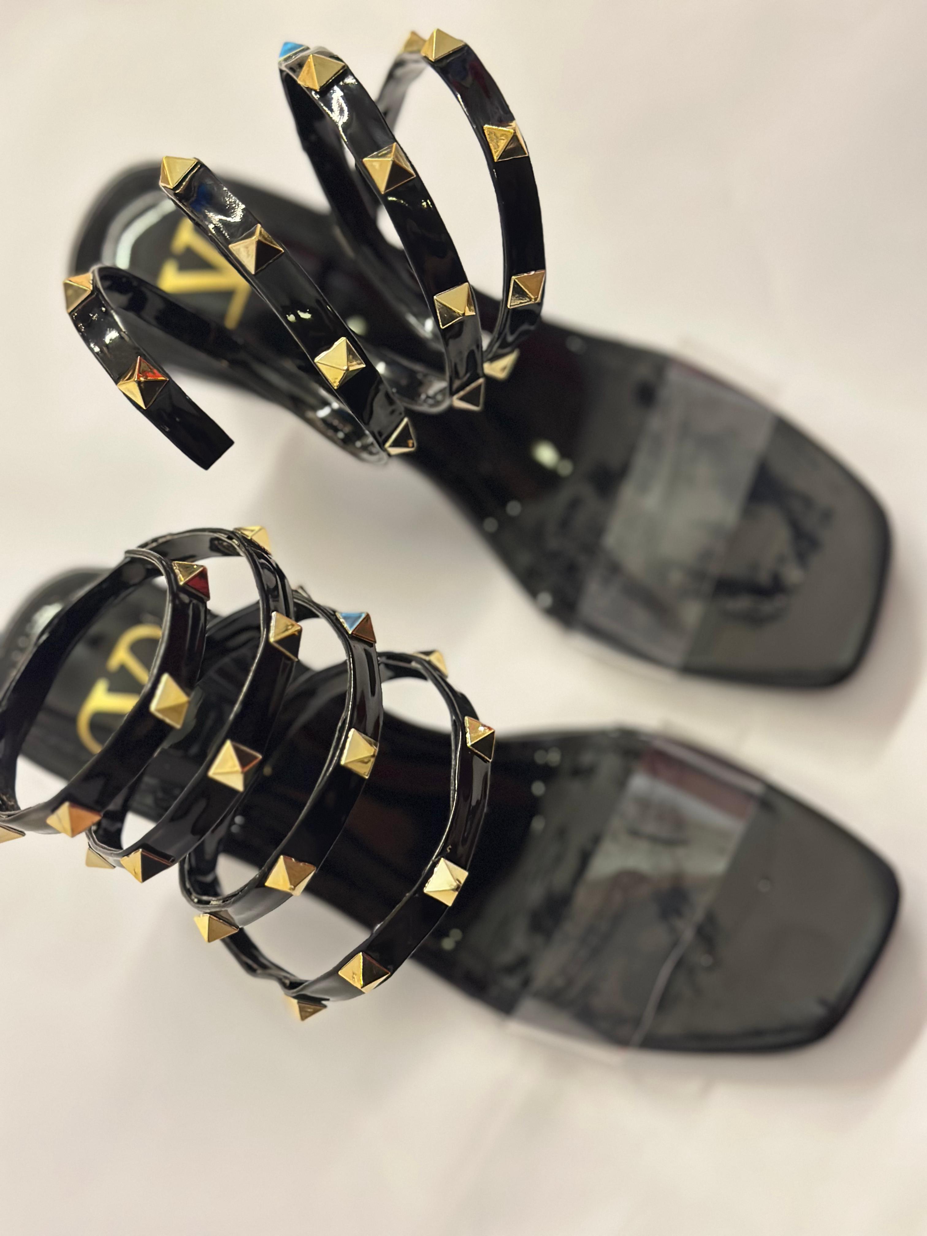Close-up of Valentino Rockstud lace-up straps – high-quality leather with metallic stud detailing on women’s sandals.