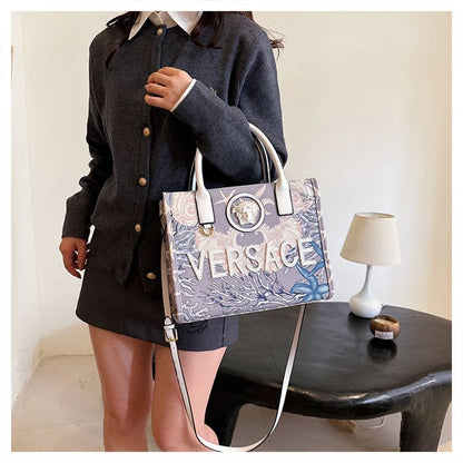 Model carrying the Versace Barocco Sea Canvas Tote Bag, displaying its stylish design and versatility.