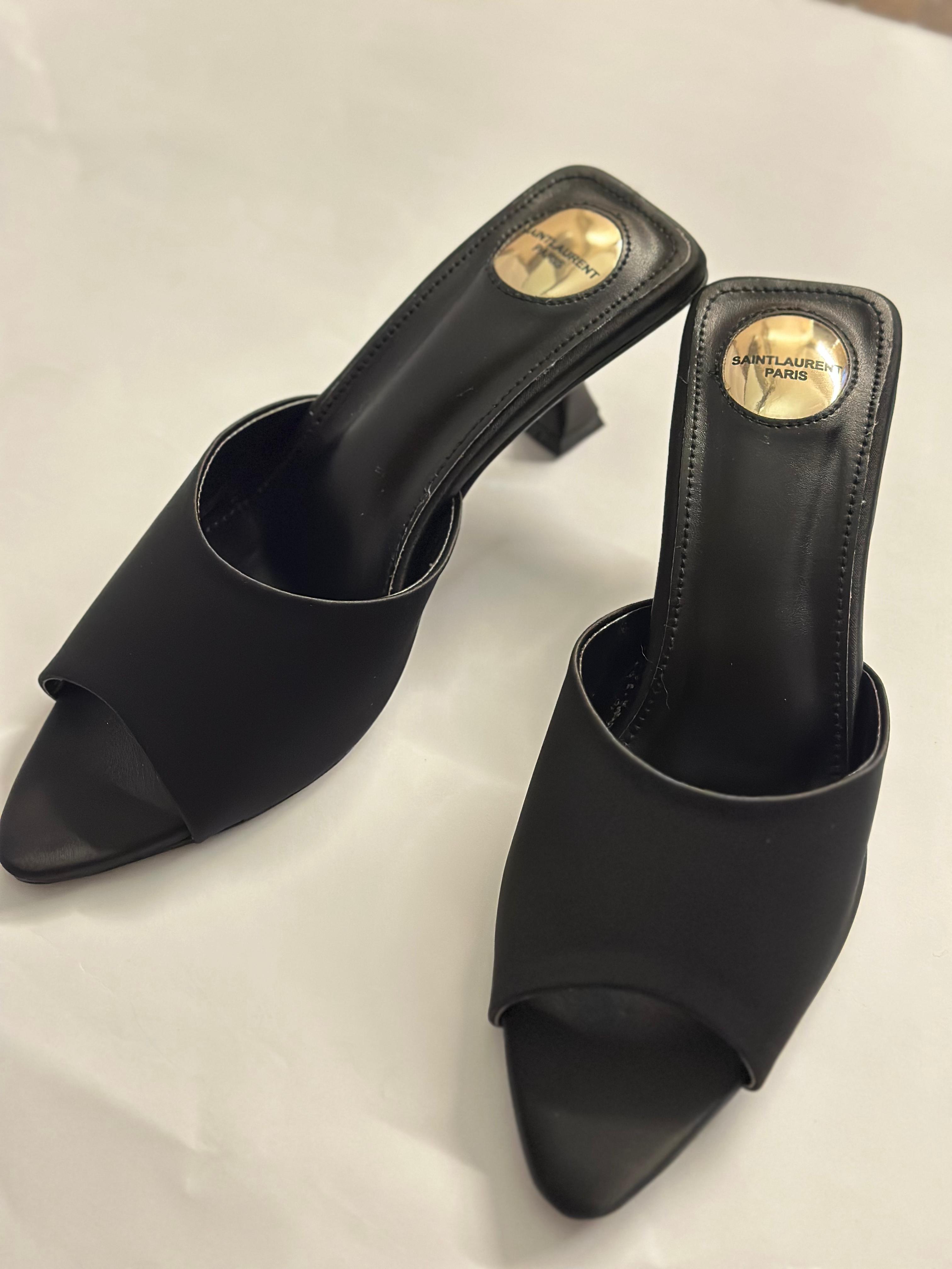 Model wearing YSL black slide heels – high-fashion women’s footwear perfect for both formal and evening outfits.